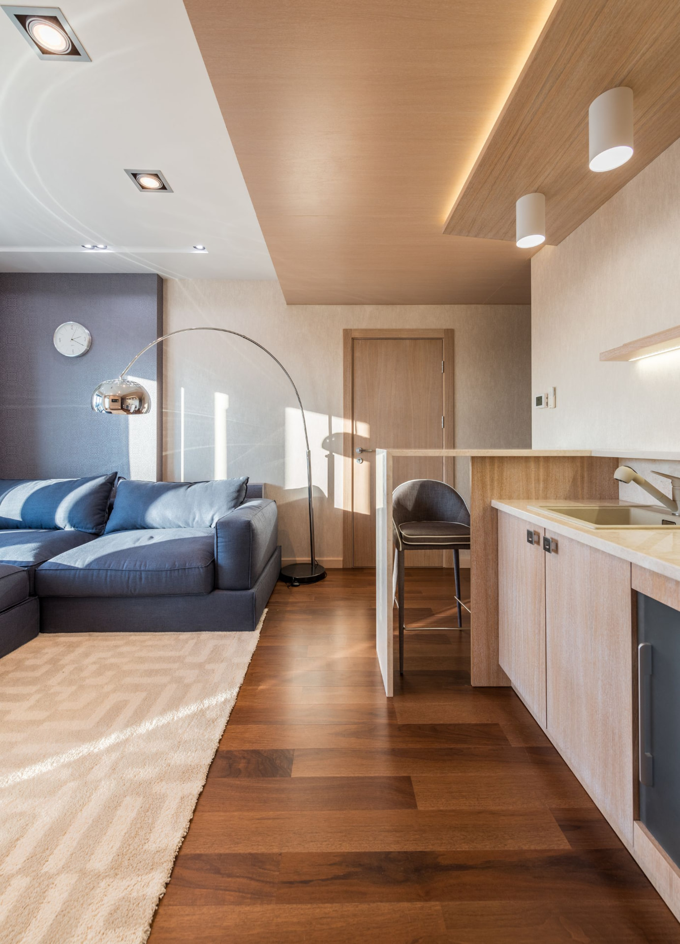 Walnut hardwood flooring running through a modern living room and kitchen